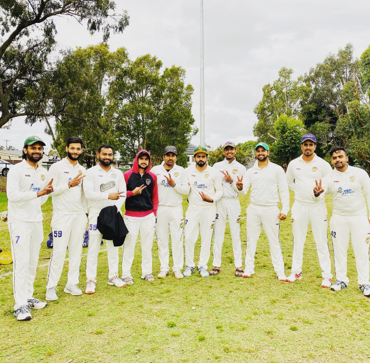 Sydney Chargers team in white cricket kit on the field